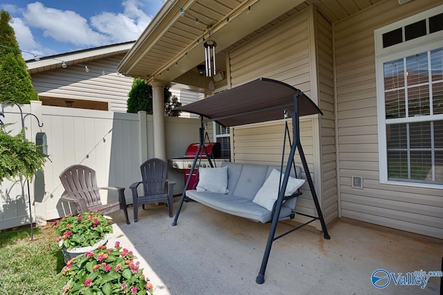 view of patio / terrace featuring fence