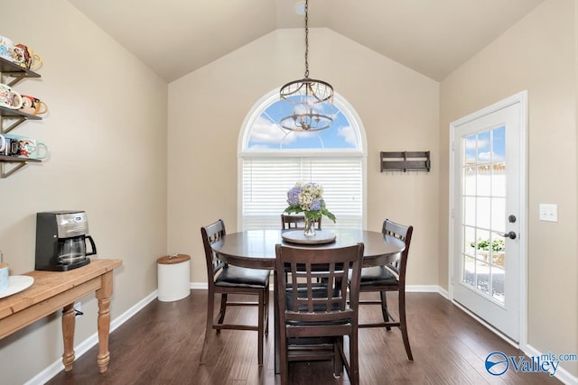 dining room with dark wood-style flooring, a notable chandelier, vaulted ceiling, and baseboards