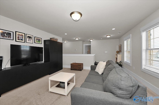 living room with baseboards and light carpet