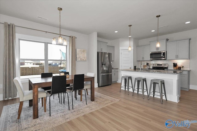 dining space featuring recessed lighting, light wood-style floors, and visible vents