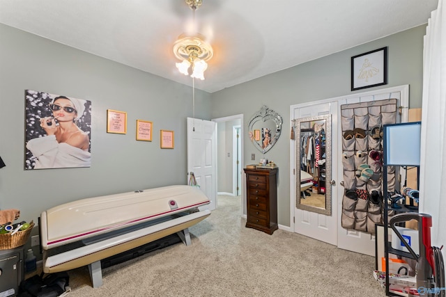 bedroom featuring light carpet, a closet, and ceiling fan