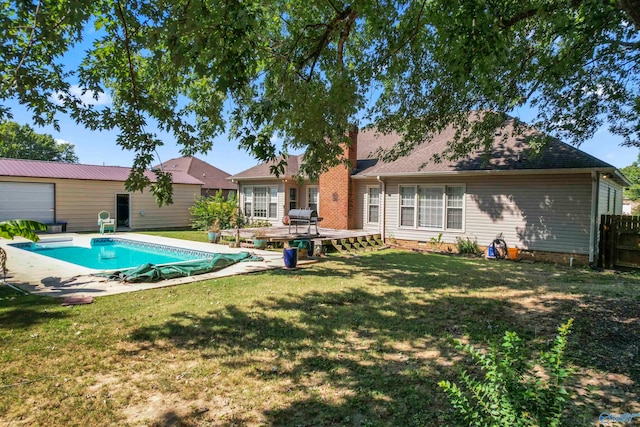 view of swimming pool featuring a yard and a wooden deck