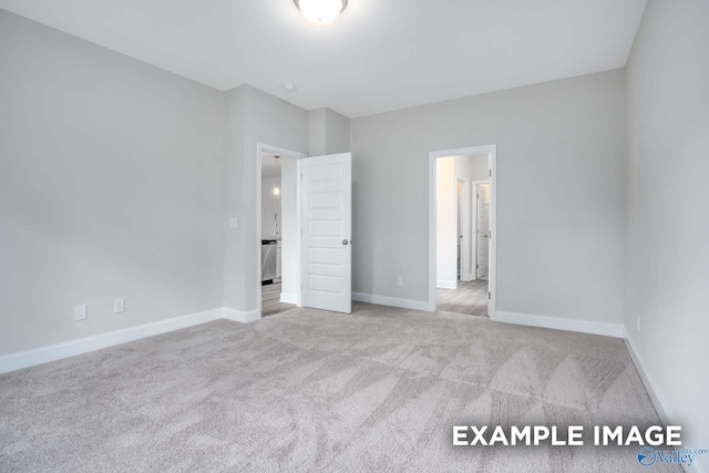 unfurnished bedroom featuring carpet floors and baseboards