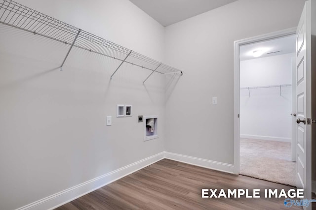 laundry room featuring hookup for a washing machine, laundry area, baseboards, and wood finished floors