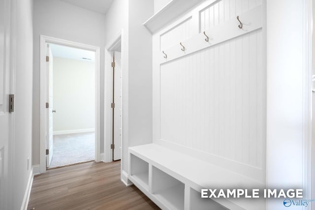 mudroom featuring baseboards and wood finished floors