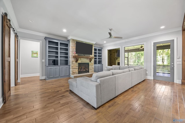 14 Blue Meadow Way, Gurley, AL 35748 - living room with ornamental molding, baseboards, wood-type flooring, a barn door, and a ceiling fan