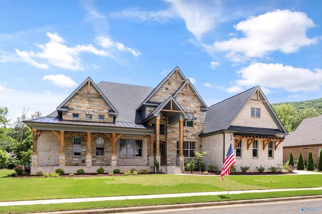 14 Blue Meadow Way, Gurley, AL 35748 - craftsman house featuring a standing seam roof, a front yard, brick siding, and covered porch
