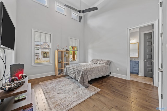 14 Blue Meadow Way, Gurley, AL 35748 - bedroom with hardwood / wood-style floors, baseboards, ensuite bathroom, and a high ceiling