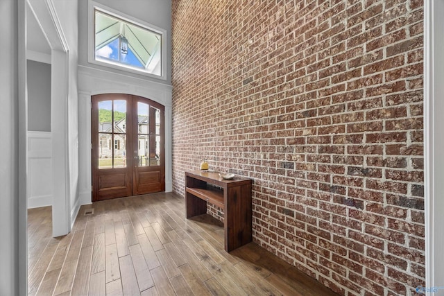 14 Blue Meadow Way, Gurley, AL 35748 - foyer featuring brick wall, light wood finished floors, and french doors