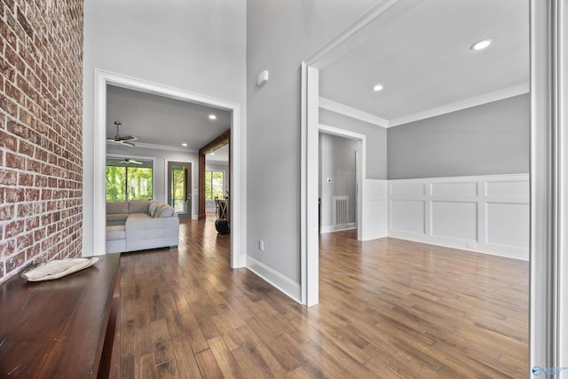 14 Blue Meadow Way, Gurley, AL 35748 - corridor featuring ornamental molding, hardwood / wood-style floors, a decorative wall, a wainscoted wall, and brick wall