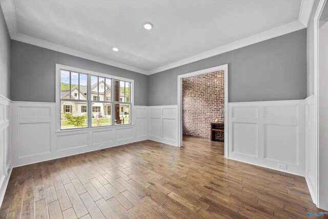 14 Blue Meadow Way, Gurley, AL 35748 - unfurnished room with a decorative wall, a wainscoted wall, wood finished floors, and crown molding