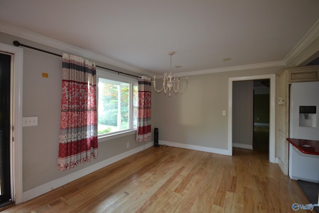 unfurnished dining area featuring light hardwood / wood-style flooring, ornamental molding, and a notable chandelier