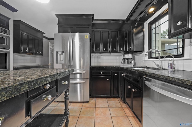 kitchen featuring backsplash, appliances with stainless steel finishes, ornamental molding, sink, and light tile patterned flooring