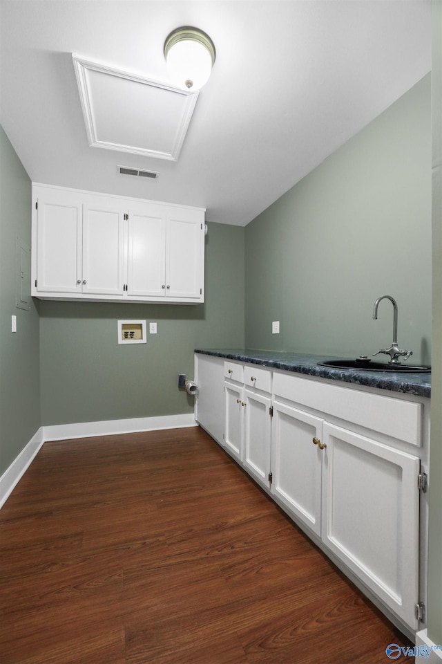 kitchen featuring dark hardwood / wood-style flooring, sink, and white cabinets