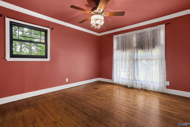 empty room featuring ornamental molding, hardwood / wood-style flooring, and ceiling fan