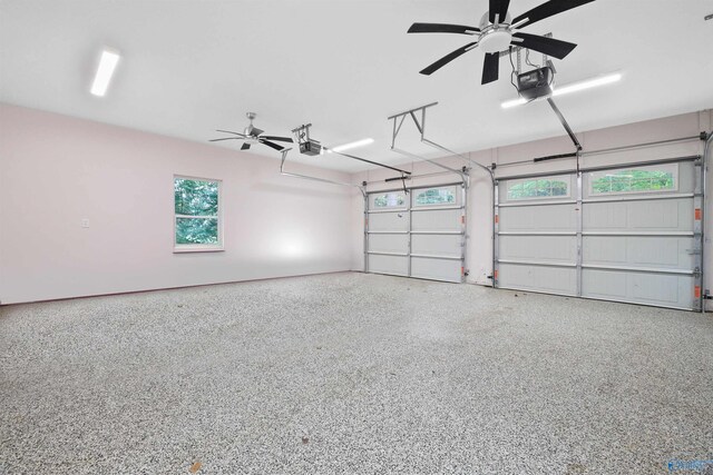 garage with ceiling fan and a garage door opener