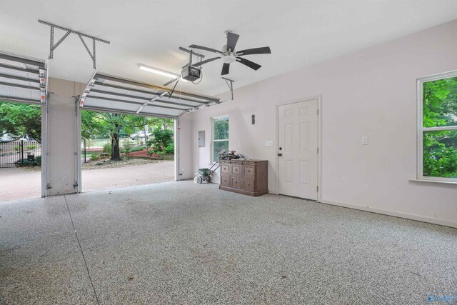 garage featuring ceiling fan and a garage door opener