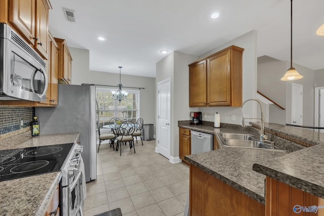 kitchen with light tile patterned flooring, stainless steel appliances, decorative light fixtures, sink, and an inviting chandelier