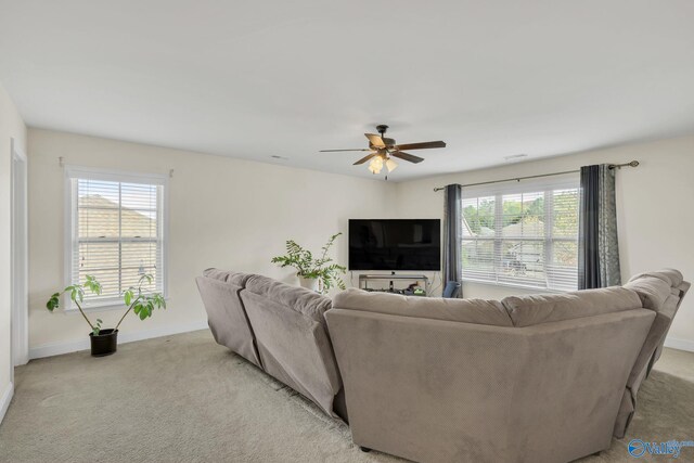 living room with light colored carpet and ceiling fan