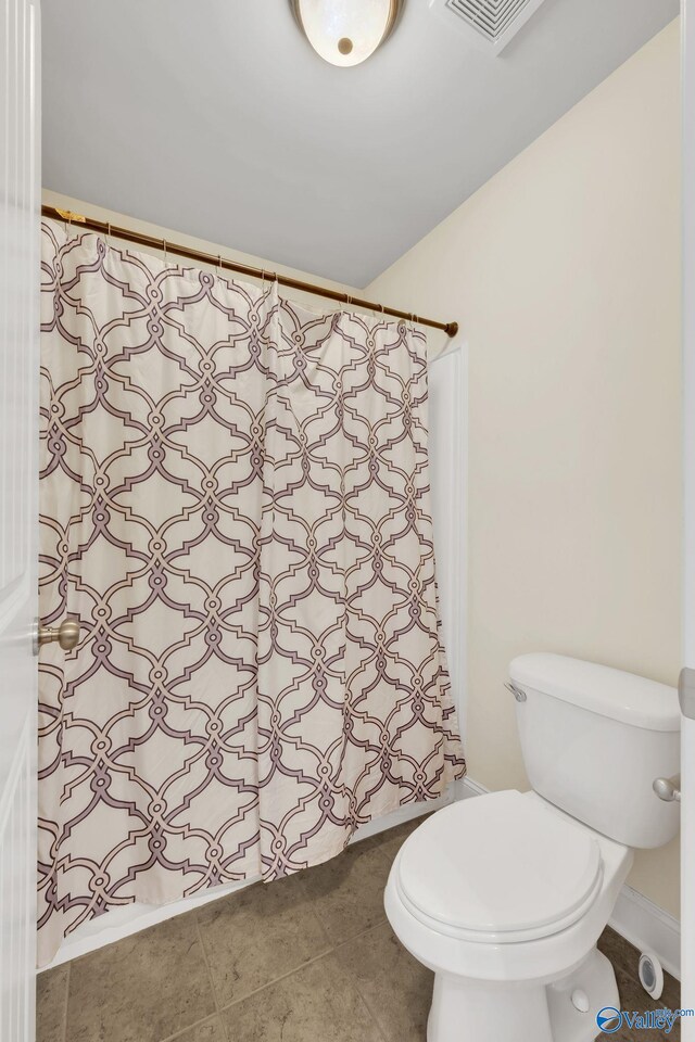 bathroom featuring tile patterned flooring and toilet