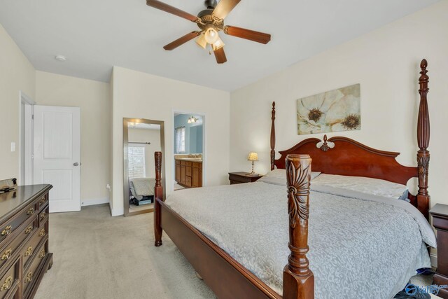 bedroom with ceiling fan, connected bathroom, and light carpet