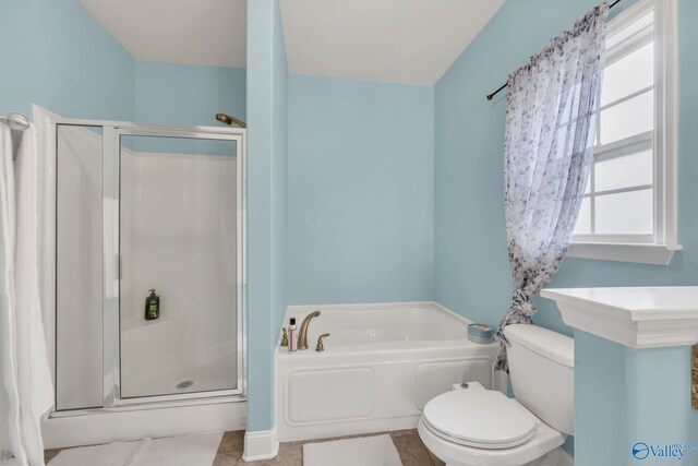 bathroom with a wealth of natural light, tile patterned flooring, and toilet