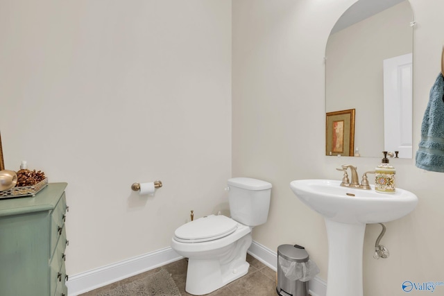 bathroom featuring tile patterned flooring and toilet