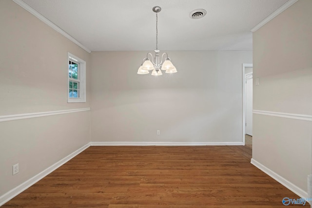 702 Royce Cir SE, Huntsville, AL 35803 - unfurnished room featuring a chandelier, crown molding, and wood finished floors