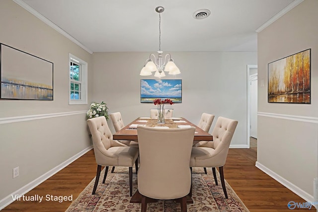 702 Royce Cir SE, Huntsville, AL 35803 - dining area featuring a chandelier, dark wood finished floors, and ornamental molding