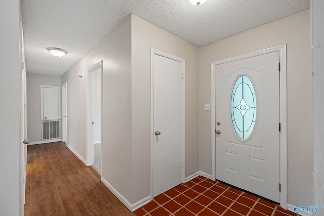 702 Royce Cir SE, Huntsville, AL 35803 - foyer entrance featuring a textured ceiling and dark wood finished floors