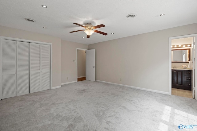 702 Royce Cir SE, Huntsville, AL 35803 - unfurnished bedroom with light carpet, a closet, connected bathroom, ceiling fan, and recessed lighting