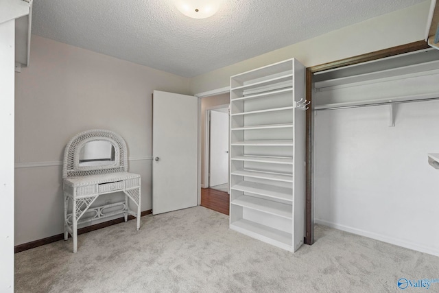 702 Royce Cir SE, Huntsville, AL 35803 - bedroom with carpet, a textured ceiling, and a closet