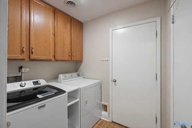702 Royce Cir SE, Huntsville, AL 35803 - washroom with independent washer and dryer, cabinet space, and brick patterned flooring