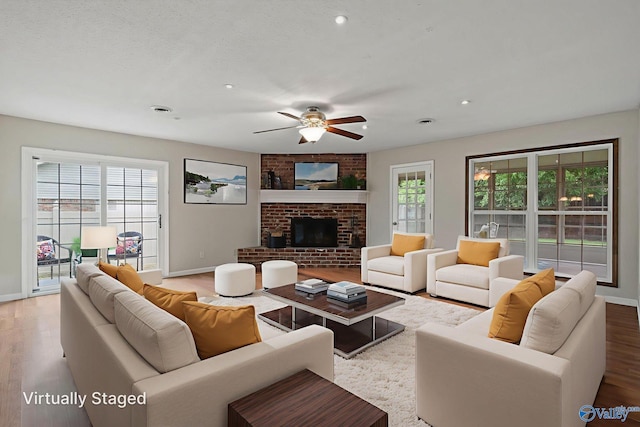 702 Royce Cir SE, Huntsville, AL 35803 - living room featuring a ceiling fan, wood finished floors, recessed lighting, and a fireplace