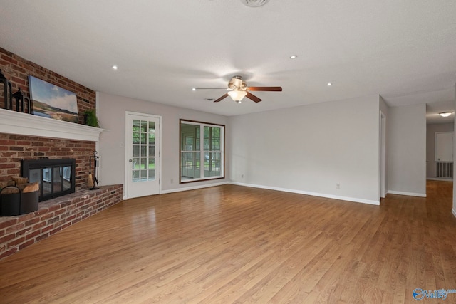 702 Royce Cir SE, Huntsville, AL 35803 - unfurnished living room featuring a ceiling fan, wood finished floors, a fireplace, and recessed lighting