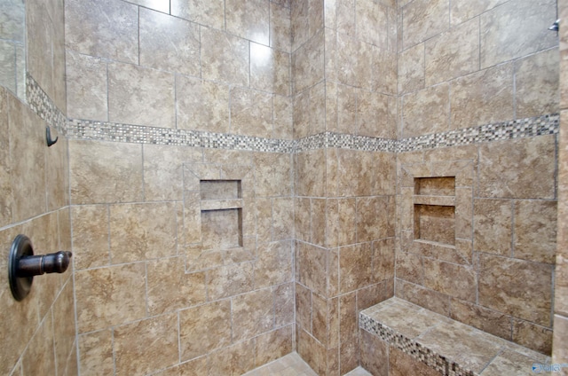 bathroom with tiled shower