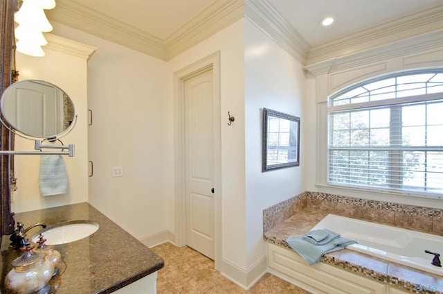 bathroom featuring a bath, vanity, crown molding, and baseboards