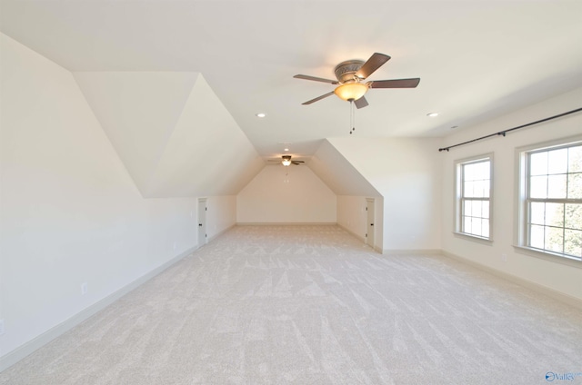 bonus room with a ceiling fan, baseboards, lofted ceiling, recessed lighting, and light carpet