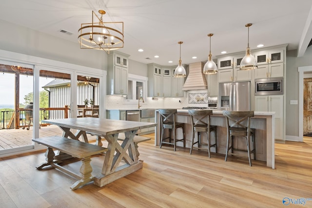 dining area featuring light hardwood / wood-style floors and an inviting chandelier