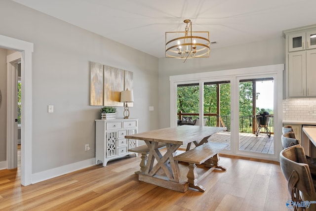 dining room featuring light hardwood / wood-style flooring and an inviting chandelier