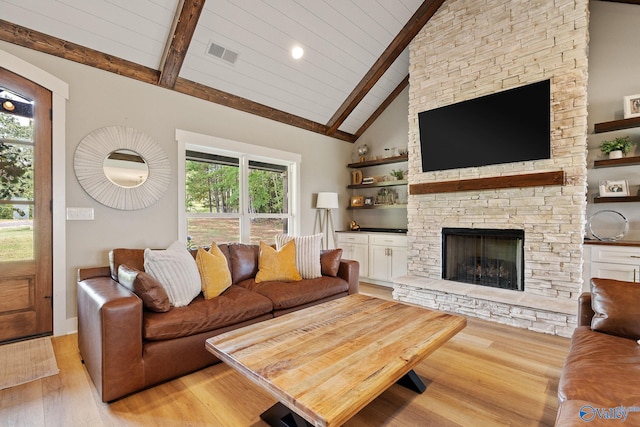 living room featuring high vaulted ceiling, light hardwood / wood-style flooring, a fireplace, beamed ceiling, and wood ceiling