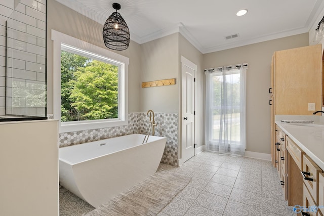 bathroom with a bathing tub, an inviting chandelier, tile patterned floors, crown molding, and vanity