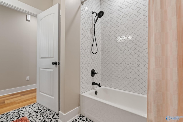 bathroom featuring shower / bathtub combination with curtain and hardwood / wood-style flooring