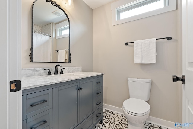 bathroom featuring toilet, vanity, and tile patterned floors