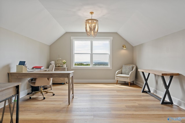 home office featuring light hardwood / wood-style floors, lofted ceiling, and an inviting chandelier