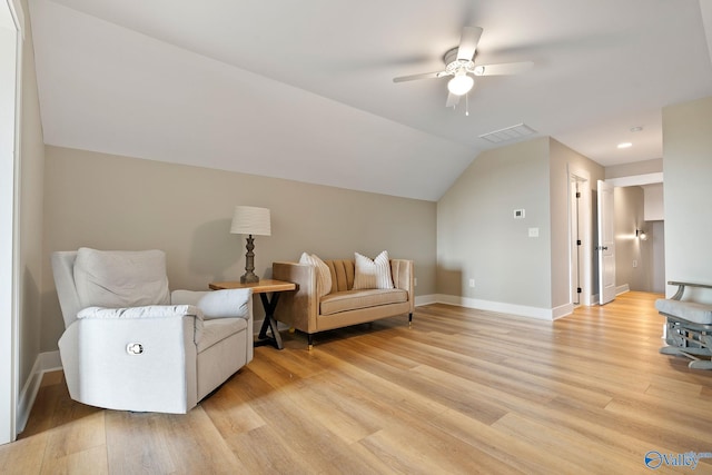 living area featuring ceiling fan, lofted ceiling, and light wood-type flooring