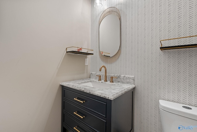 bathroom featuring vanity and toilet