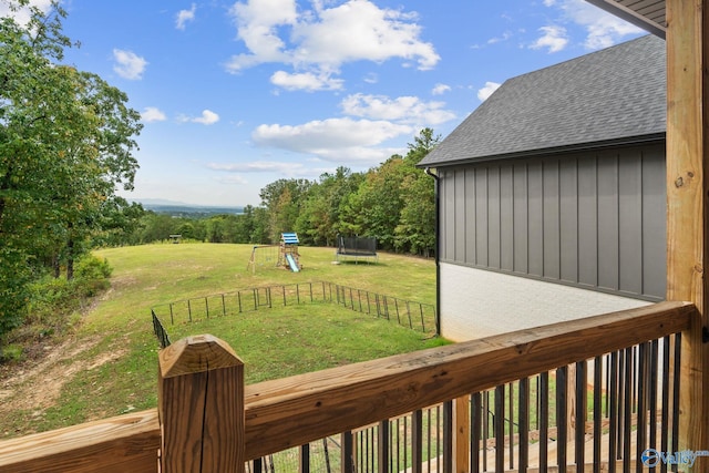 view of yard with a playground and a trampoline