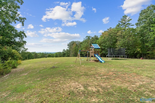 view of yard with a playground and a trampoline