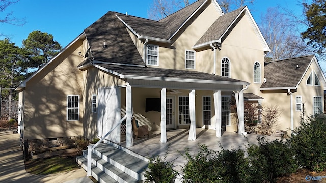 back of property with a porch